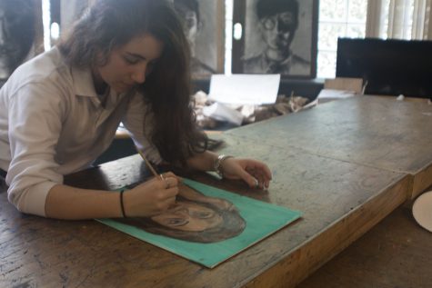 Junior Nicole Kanaras works on her latest self-portrait. Kanaras has been creating art since she was a child and plans to take AP Studio her senior year.  
