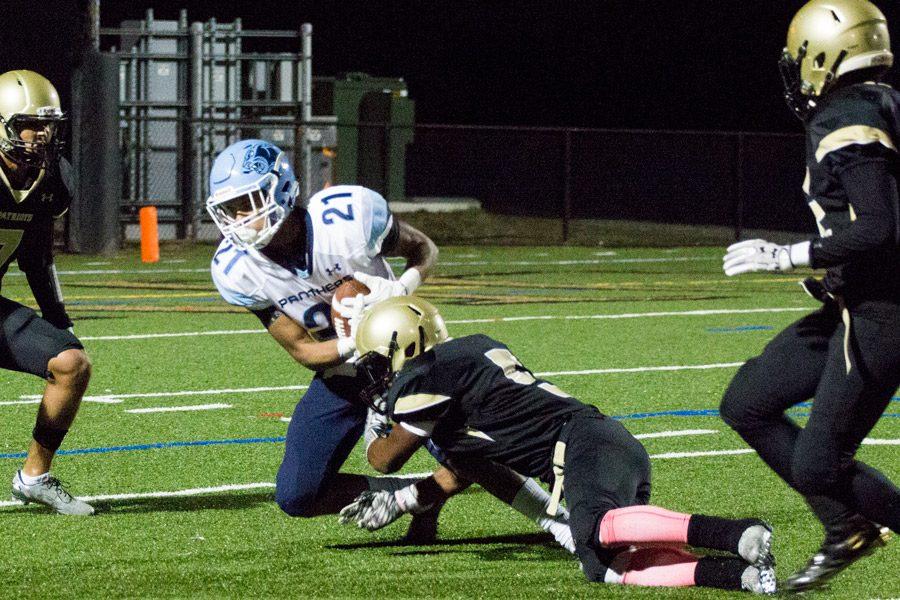  Senior cornerback and wide receiver Darius Baugh tackles an opponent in the game against St. Vincent Pallotti High School on Oct. 14. The football team finished with a 1-9 overall record this season.