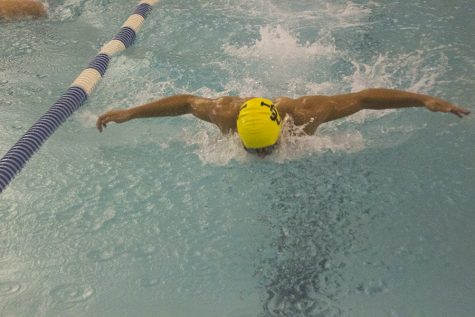 Junior Luke Ensor is close to his opponents as he approaches the final turn of the mens 100m butterfly. On Wednesday, Nov. 30, the mens swimming team competed against Beth Tfiloh Community School, losing the meet 59-91.