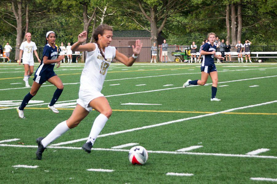 Racing down the field on a fast break, junior striker Marisa DiFonso drives towards the goal against Notre Dame Preparatory School on Oct. 4. The varsity womens soccer team finished 3-11 overall, but made it to the semifinals during playoffs, losing to Archbishop Spalding, 2-0 on Nov. 3.