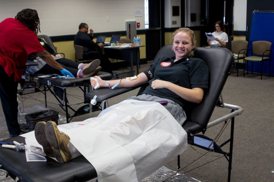 Senior Anna Smith smiles as she donates blood at the Annual JC Blood Drive on Jan. 27. Every year, social studies teacher Rodney Johnson coordinates a drive with American Red Cross Association for students to donate their blood.