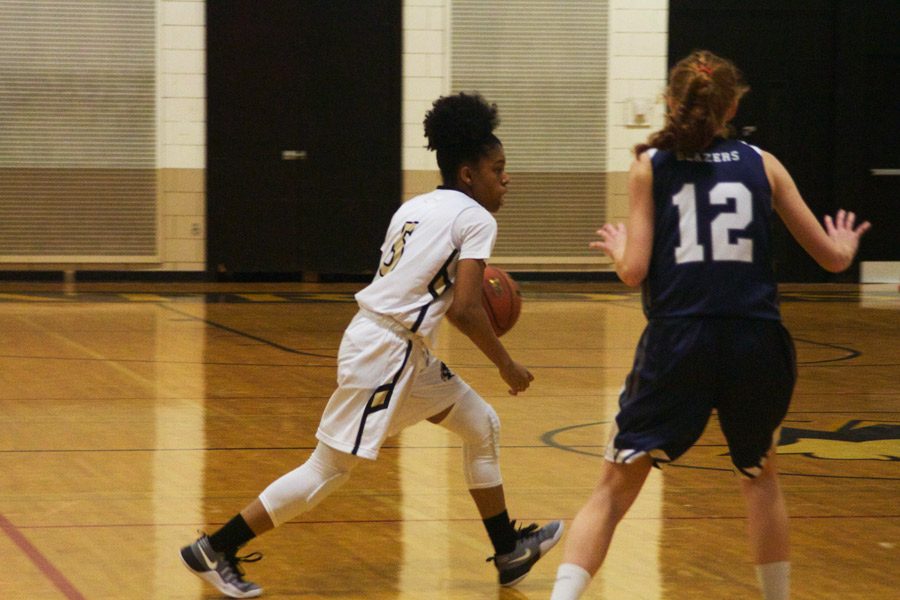 Junior Myah Savage fakes out a defender in a game against Notre Dame Preparatory School on Wednesday, Dec. 7. Off the court, the womens basketball team gave back to the community by serving veterans at Perry Point VA Medical Hospital.