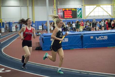 Junior Hadley Leishman races around the track during her leg of an 800 meter relay. The womens indoor track team competed in an IAAM/MIAA meet at PG Center on Jan. 6 and placed 15 out of 37 teams with a score of 52.5.