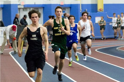 Junior Jared Vogel sprints his leg of the 200m relay at the IAAM/MIAA Indoor Track and Field Championships at PG Center on Jan. 27. The mens varsity indoor track team placed 11th out of 12 teams with a score of 8, and the womens varsity indoor track team placed fourth out of eight teams.