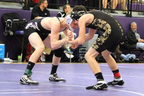 Freshman CJ Polesovksy prepares to take down a Mount Saint Joseph wrestler at the beginning of his match. The wrestling team competed in the MIAA Championships on Saturday, Feb. 10, and came in eighth place out of 17 teams.