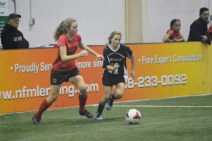 Freshman Katie Hormes fights for the ball with a defender in a game against Friends School. The womens indoor soccer team finished the season with a 6-2-2 record and won the IAAM A Conference Championships on Feb. 4.