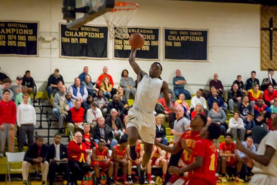 Junior guard Montez Mathis rises up for a dunk in the first quarter against Calvert Hall on Tuesday, Feb. 21. The mens varsity basketball team fell to Calvert Hall 78-84 in the MIAA A Conference Quarterfinals.