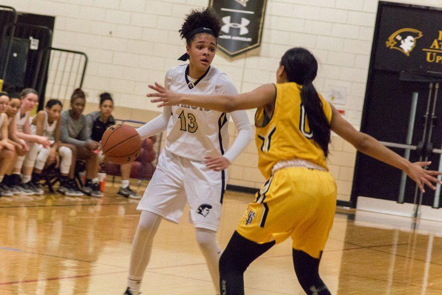 Sophomore Jordan Wakefield holds the ball while being defended by a St. Frances Academy player. The womens basketball team finished the season with a 10-12 overall record with a 2-10 in-conference record.