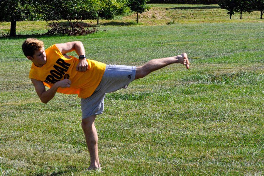 Senior Andrew Moss practices Taekwondo in his backyard. Moss started Taekwondo in December 2015 and practices six days a week in order to prepare for competitions.