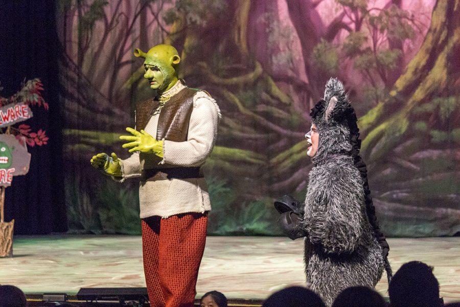Sophomore Joshua Robinson performs a song on stage as Shrek with Senior Zachary Miller as Donkey in Shrek The Musical on Friday, March 17. The Theatre Department put on four performances of Shrek The Musical on Friday, Saturday, and Sunday, along with matinees throughout the week. 