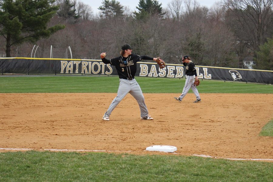 During warm ups before the game against Archbishop Spalding on Thursday, March 30, senior third baseman Zach Rasmussen throws the ball to a fellow teammate. The baseball team lost the game with a final score of 0-6. 