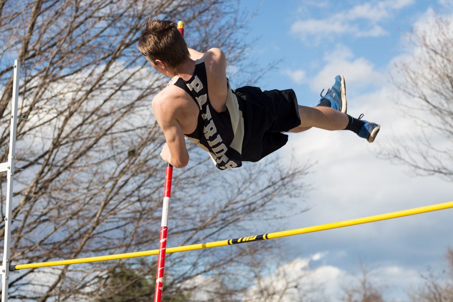 Junior David Pajerowski, the teams top pole vaulter, clears the bar. Pajerowski finished the meet with a final height of 106.