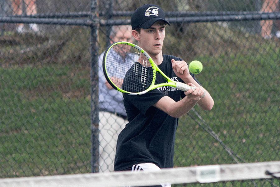 Senior Andrew Kappel runs to strike the ball in a tennis doubles match. Kappel and senior Daniel Robinson played their first doubles match of the year at home against Beth Tfiloh on Tuesday, April 4, and won 2-1. 