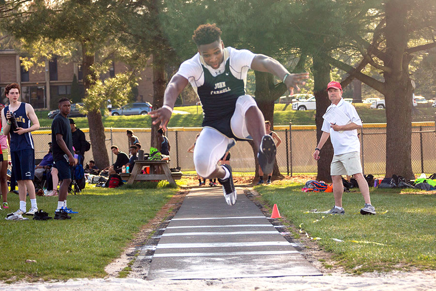 Senior Avery Jones leaps in the triple jump during the home meet on Tuesday, April 11. Jones qualified for the MIAA A Conference Championships with a distance of 3911. 