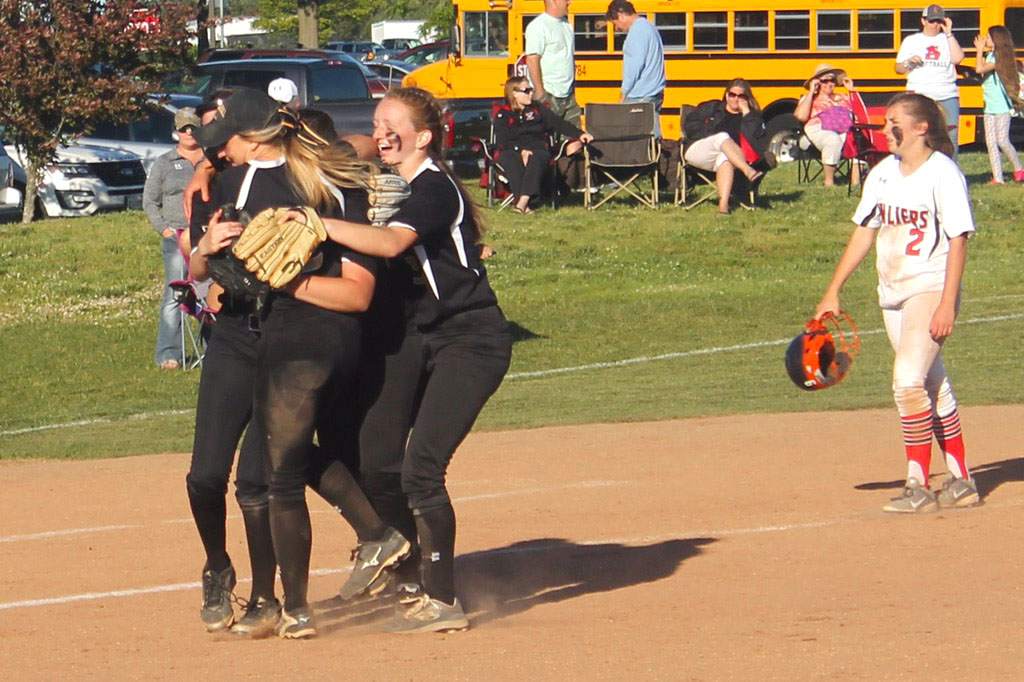 Softball team members embrace each other after winning in the semifinals against Spalding on May 15. The final score was 9-3, and they then advanced to the championships against Mount de Sales on May 16 where they won 7-2. 