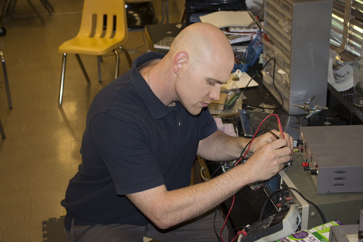 Physics teacher Anthony Davidson focuses as he tests computer equipment for a freshman building a gaming computer. This is Davidsons second year at JC, and he enjoys helping students in class as well as with their personal endeavors.