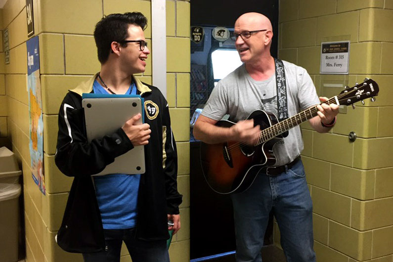 Fine Arts and Social Studies teacher Robert Schick calls on freshman Mikey Shock to finish the rest of the Its Thursday song. Only brought back recently, students can look forward to hearing this song in the hallways every Thursday morning.