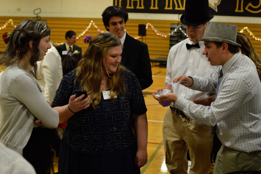 Lauren and Danielle, two guests who attended the Special Needs Prom at JC, watch as senior Steven Kutcher performs a card trick before the dance begins on March 26. Since August, Kutcher has developed a passion for performing magic tricks and has performed on several different stages such as the Variety Show and at birthday parties. 