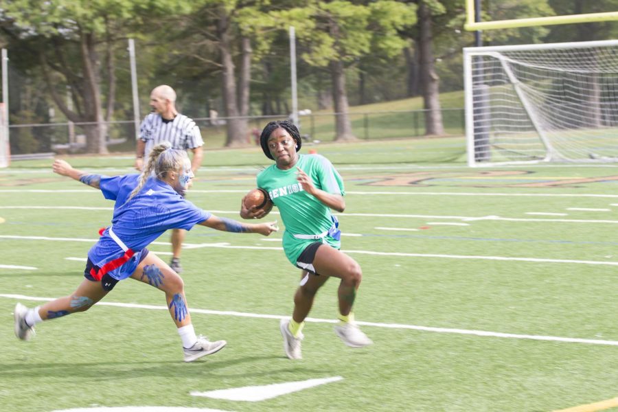 Senior Chika Chuku sprints away from a junior defender during the Powderpuff game on Thursday, Oct. 5. The Powderpuff game occurs every year during Spirit Week between the junior and senior classes.