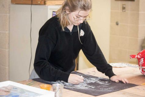 Junior Lauren Wright works on her latest piece of art work, a scary face for Halloween. Wright has been taking art classes since her freshman year and is currently taking Honors Studio 3. 