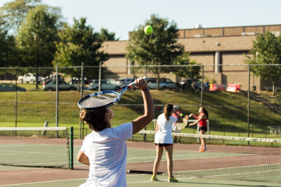 Senior Ellee Perri serves the ball in a tennis doubles match on Tuesday, Oct. 3. JC lost to Friends 5-0.
