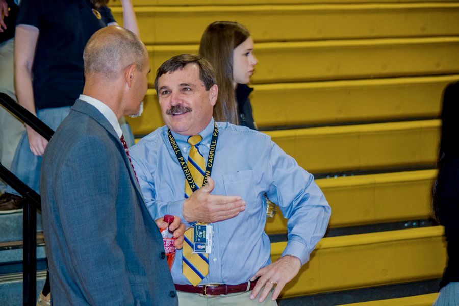 President Steve DiBiagio talks to social studies teacher and Department Chair Jake Hollin. In order to learn more about student life, DiBiagio shadowed with a student on Oct. 12.