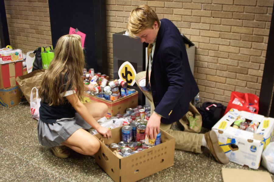 Sophomores Garrett Smith and Kendall Rittmeyer sort cans into boxes for the annual Patriots CAN Do Thanksgiving Food Drive. Food donations will be given to the Manna House in Bel Air and St. Francis De Sales Church in Abingdon.