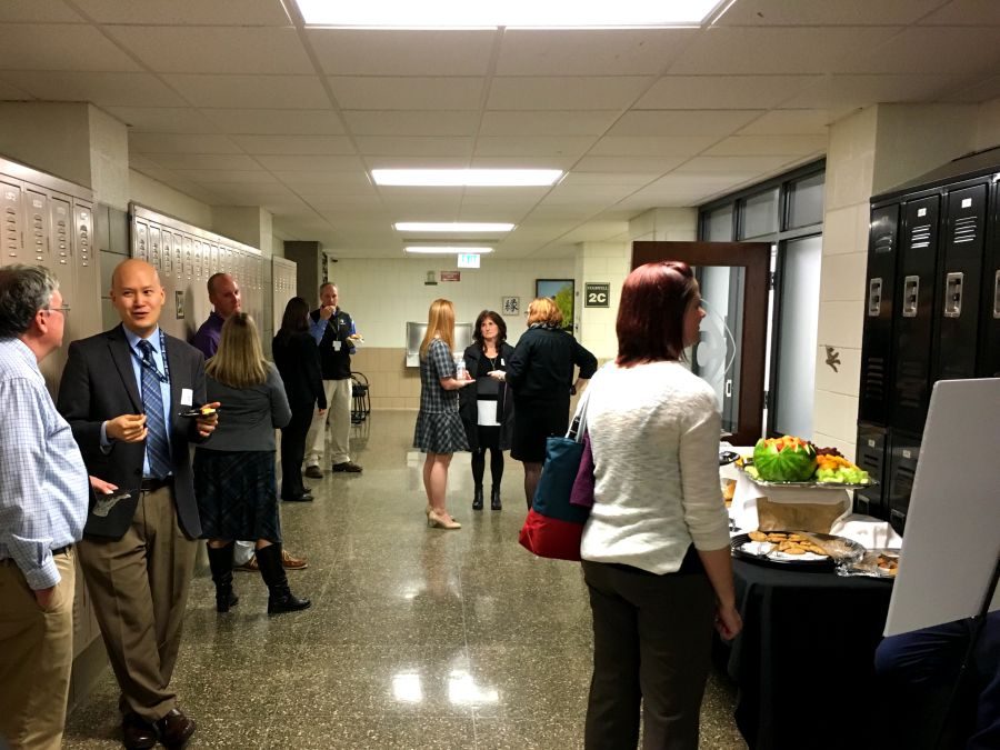 Former and current JC teachers converse and enjoy refreshments after seeing presentations on the future of science laboratories and electives.