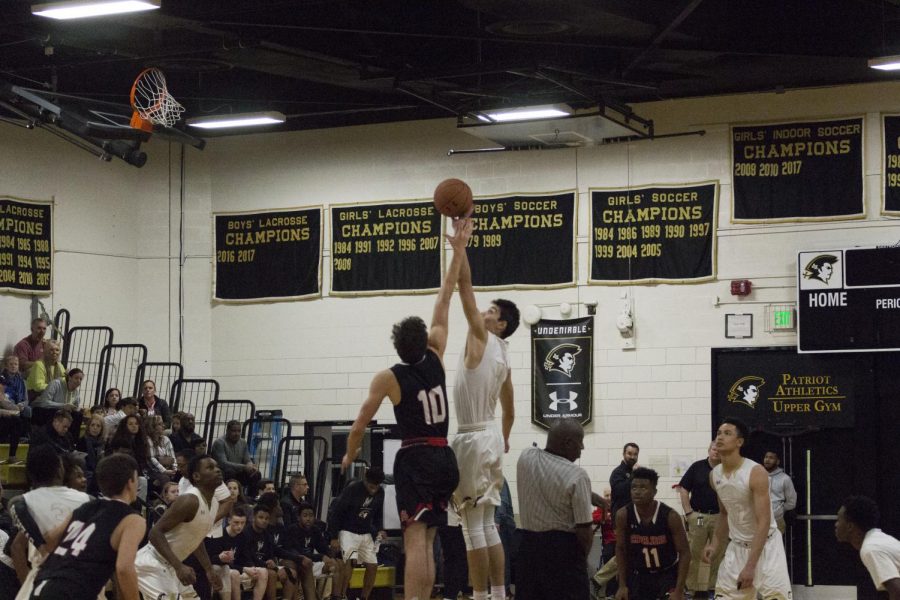 Junior Yavuz Gultekin reaches for the ball at the start of the game. On Friday, Feb. 2, the mens varsity basketball team faced the Archbishop Spalding Cavaliers and won 84-59.